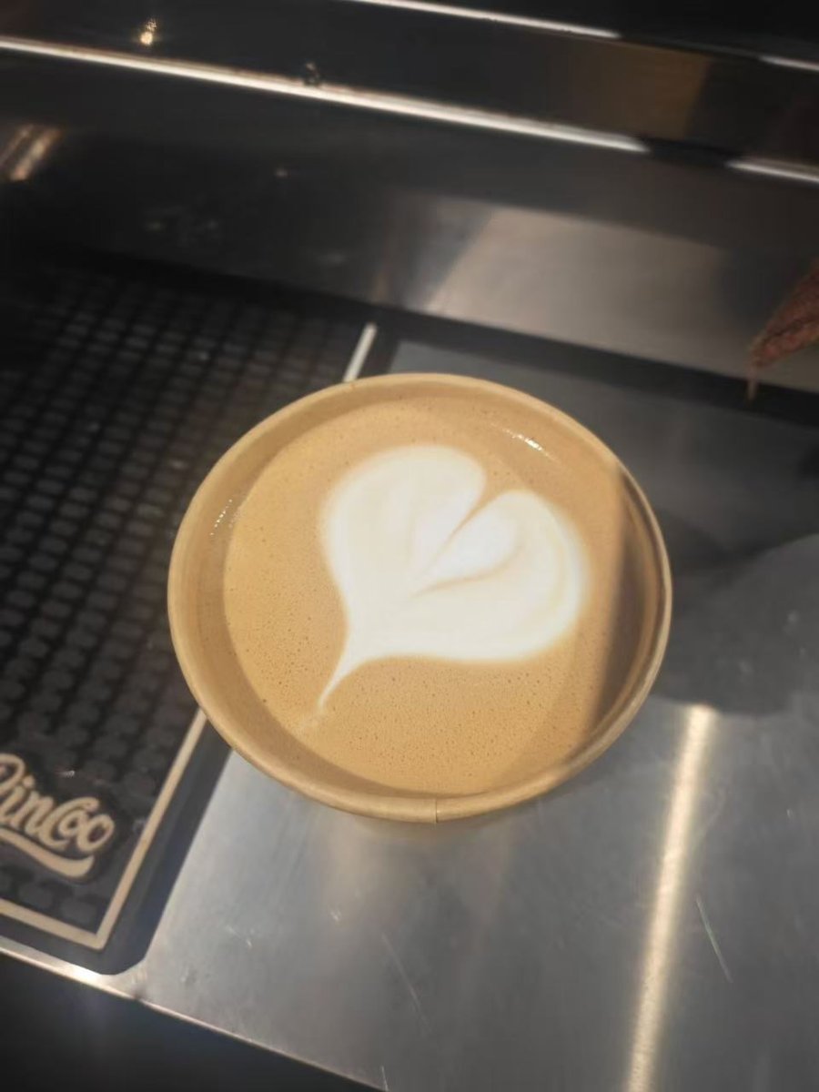 Heart latte art in a takeaway cup